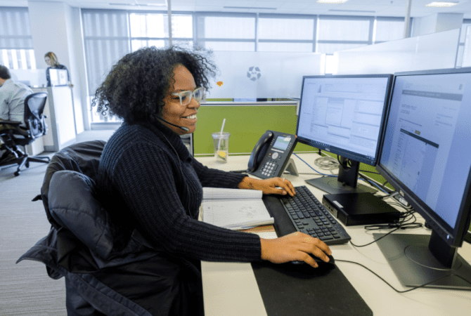 CoStar office employee works at computer desk
