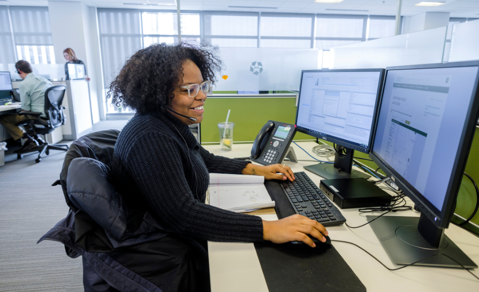 CoStar office employee works at computer desk